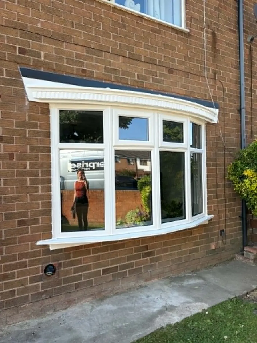 Bow window installation on a brick house